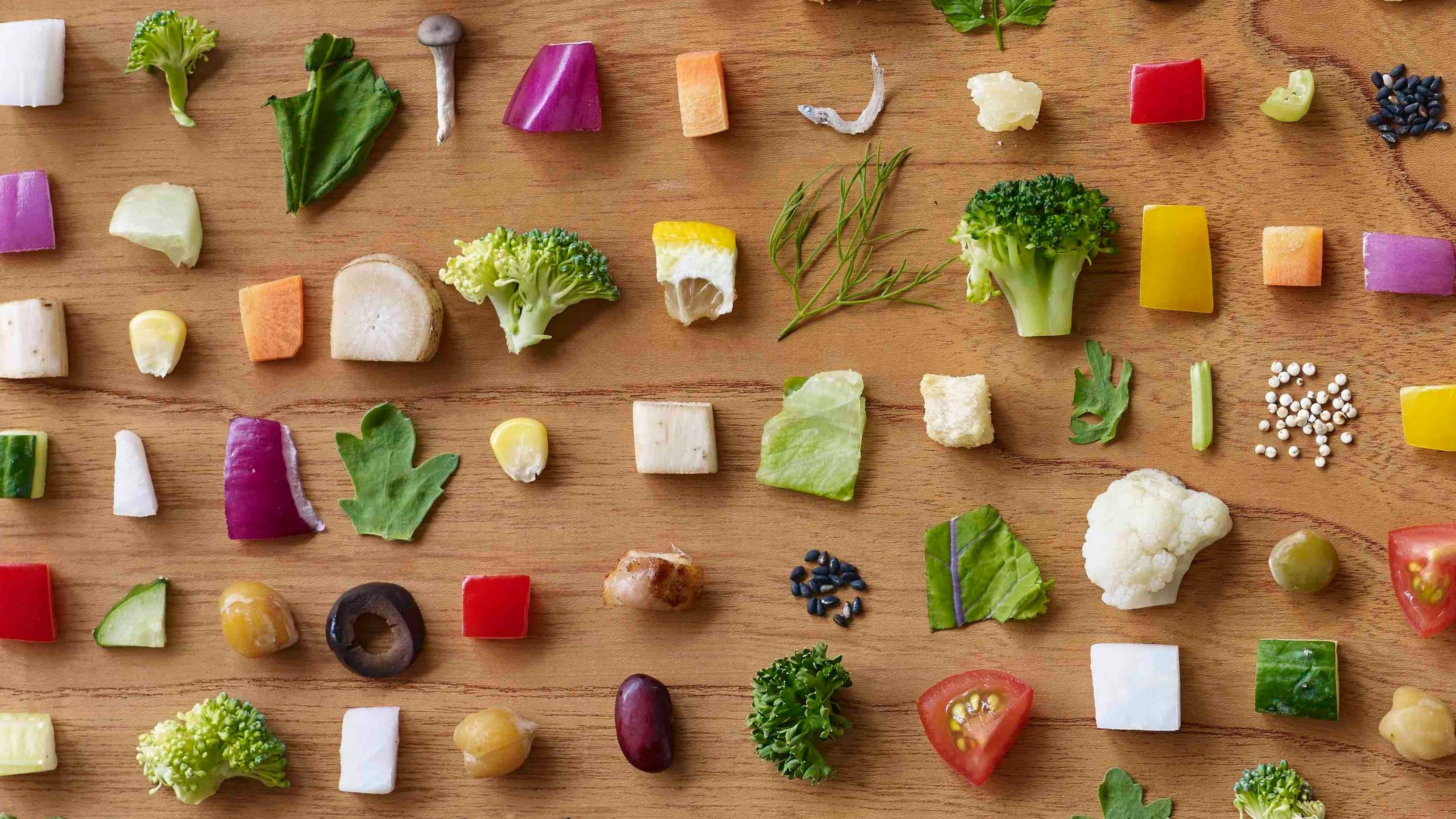 Colorful assortment of vegetables arranged neatly on a wooden surface