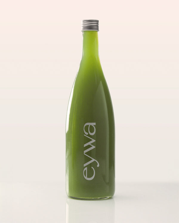Green organic celery juice bottle with 'eywa' branding on a white background