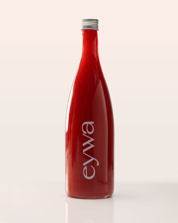 Red organic watermelon juice bottle with 'eywa' branding on a white background